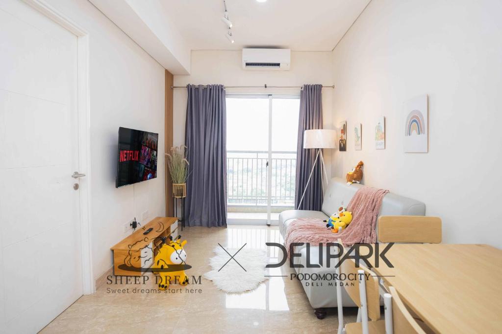 a living room with a bed and a table in it at SheepDream 17BC DeliparkMall 2Bedroom, 1Bathroom in Medan