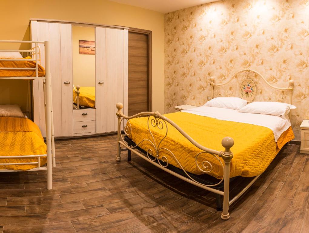 a bedroom with a bed and a bunk bed at Dimora Delle Grotte in Castellana Grotte