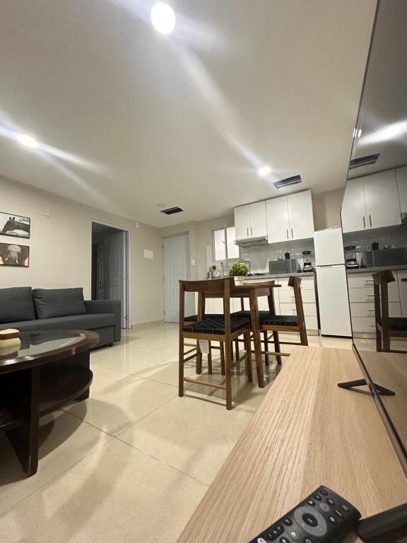 a living room with a couch and a table at Apartamentos Roman in Santo Domingo