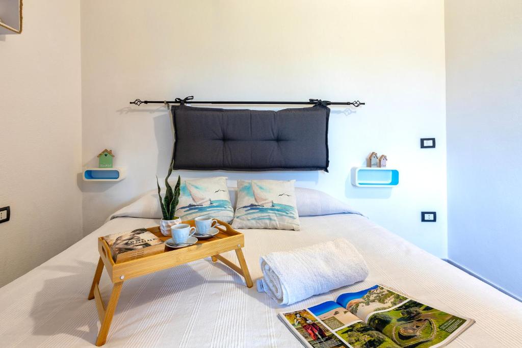 a bedroom with a bed with a table on it at Villino Giovanni New 2026 in Costa Paradiso