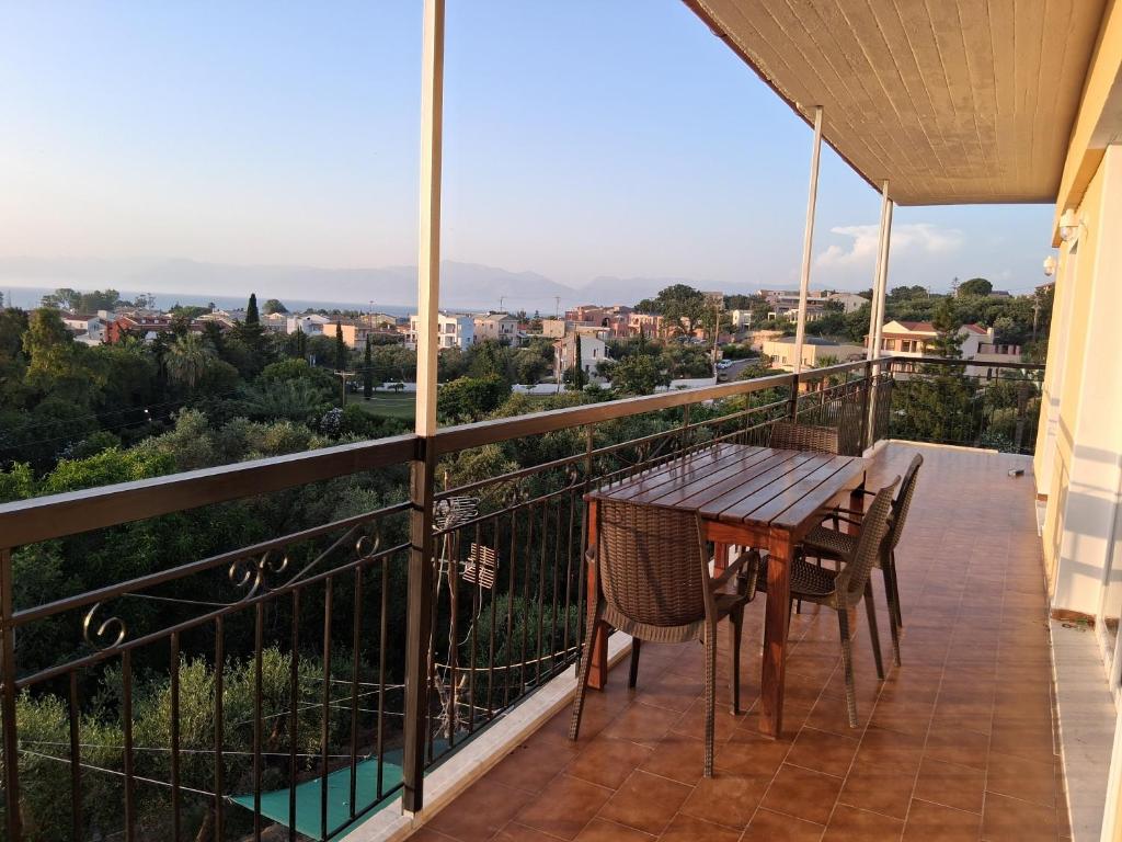 a balcony with a table and chairs and a view at Villa Elia Acharavi in Acharavi