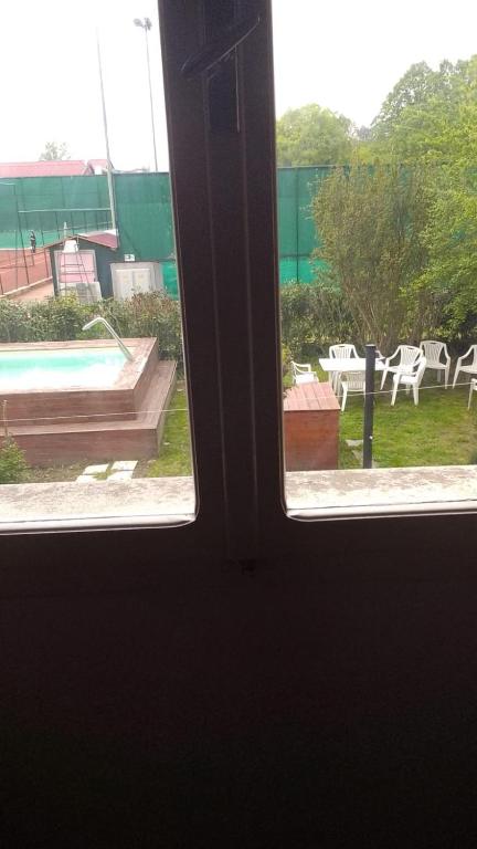 an open window with a view of a pool at Casa venturini in Imola