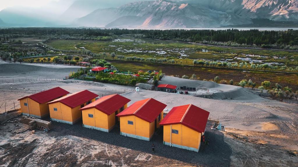 an overhead view of a row of houses with red roofs at The Crescent Resort in Skardu