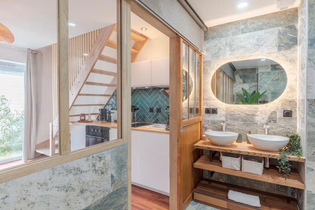 a bathroom with two sinks and a staircase at Le Grand Bastion, Luxury T2 - avec climatisation in Lescar