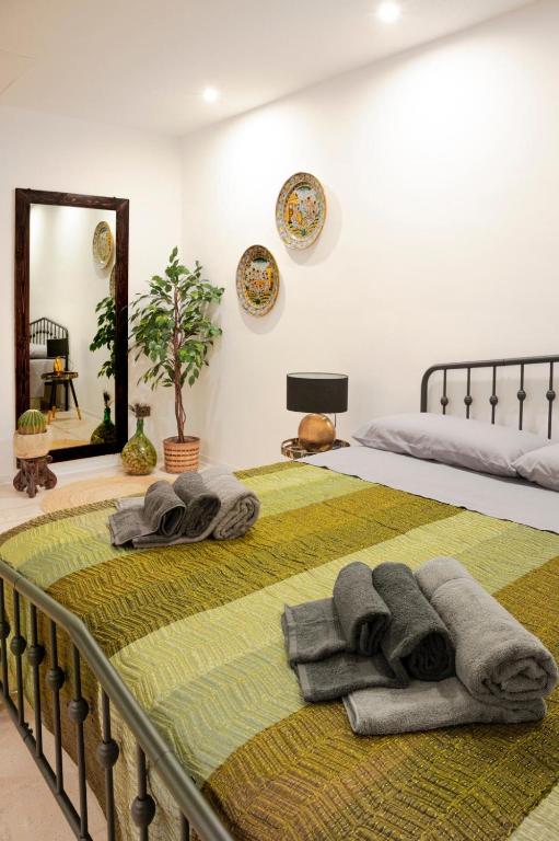 a bedroom with a bed with towels on it at Corina Secret Rooms in Martano