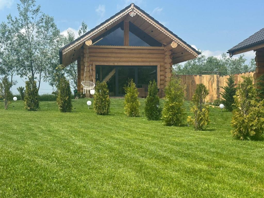 een blokhut met een basketbalring in de tuin bij Cabana de la Stână in Rîşnov
