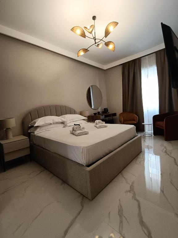 a bedroom with a large bed and a mirror at Luxury Rome Vatican's Garden in Rome