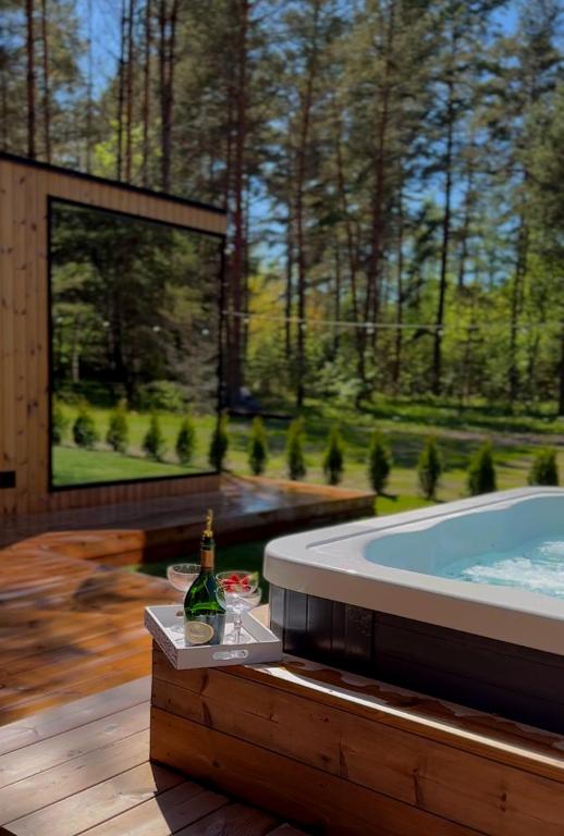a jacuzzi tub with a view of a garden at Luxury Tahkuranna SPA villa Pärnu in Laadi