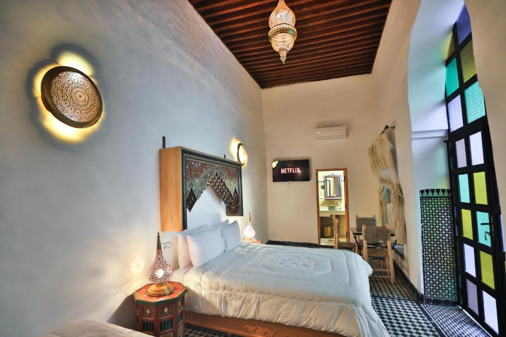Postel nebo postele na pokoji v ubytování Riad Old City Palace