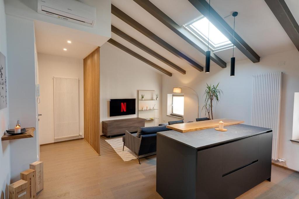 a large living room with a couch and a table at Centro Storico Cormons - Luxury Design and Comfort in Cormòns