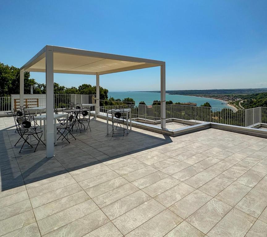 a pavilion with a table and chairs on a patio at Villa Caravaggio Comfort e Relax in Rocca San Giovanni