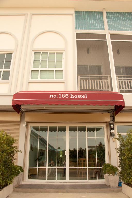 a store front of a building with a red awning at no 185 hostel in Ban Pak Nam Pran