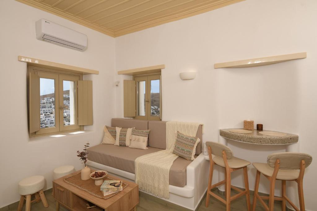 a living room with a couch and a table at Vento Apartment in Astypalaia Town