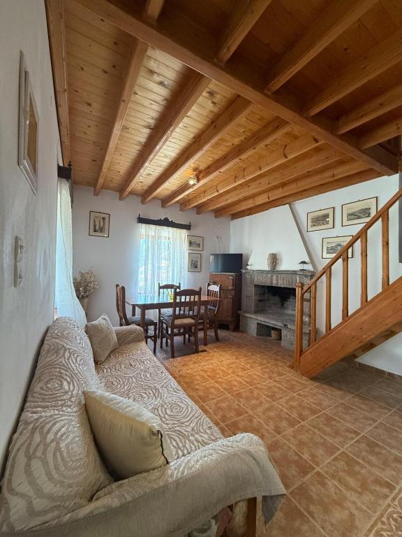 a living room with a couch and a table at Traditional House in Pámfylla