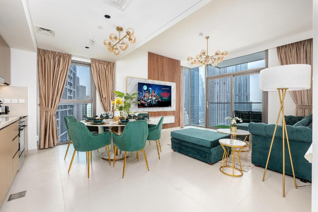a living room with a couch and a table and chairs at Stylish 2BR with Boulevard View & 5 min from Dubai Mall in Dubai