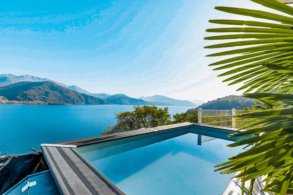 a swimming pool with a view of a lake at Casa Samara in Cannobio