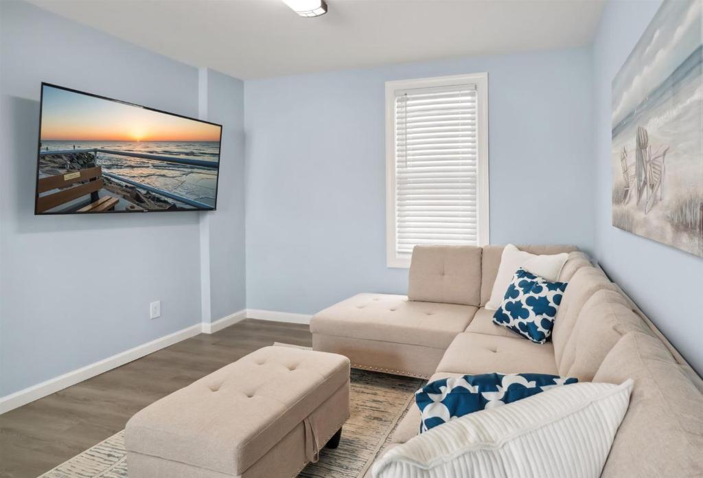 a living room with a couch and a tv on the wall at 110 E 24Th Ave, Unit A in Wildwood