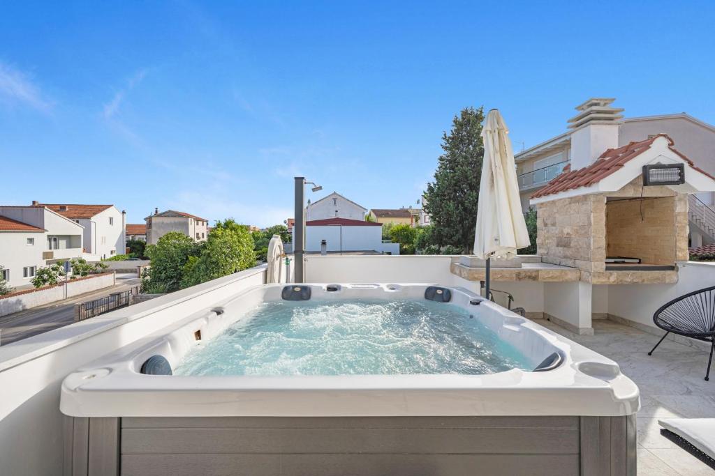 a hot tub on the roof of a house at Apartments 1 with pool and private jacuzzi in Vodice