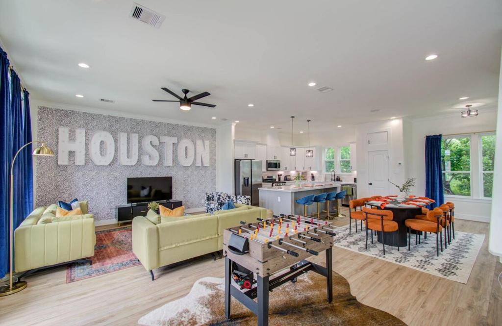a living room with a houston sign on the wall at HTX Modern Retreat with Rooftop Cinema in Houston