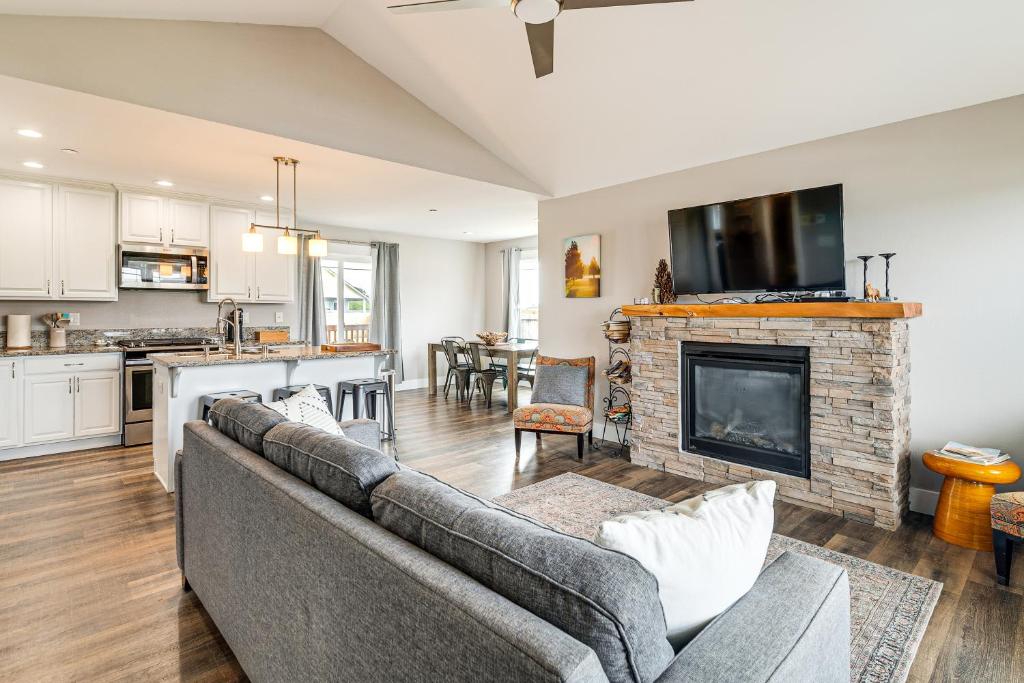 a living room with a couch and a fireplace at Hot Tub Modern Ocean Shores Home, 2 Mi to Beach! in Ocean Shores