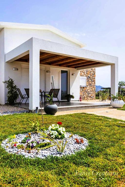 a house with a flower arrangement in the grass at Anna Maria's Maisonette II in Kardamaina
