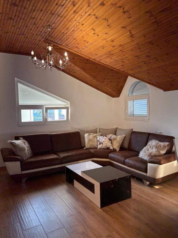 a living room with a couch and a coffee table at Shkodra Rooms in Shkodër