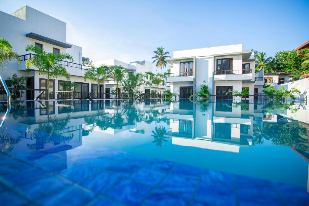 an image of a swimming pool in front of a building at Breedon Residence Hotel in Anuradhapura