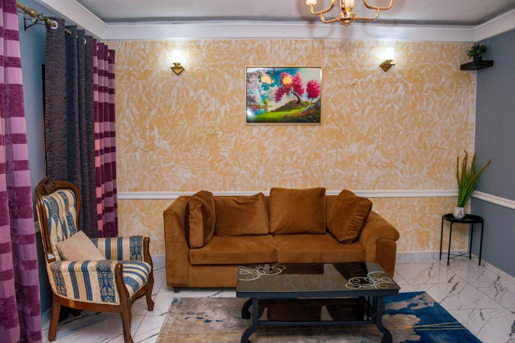 a living room with a couch and a chair at Residence JTC in Douala