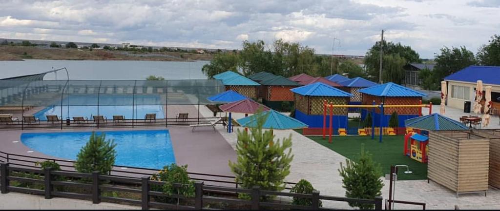 a large swimming pool with a playground and a water park at Boat Station in Kapchagay