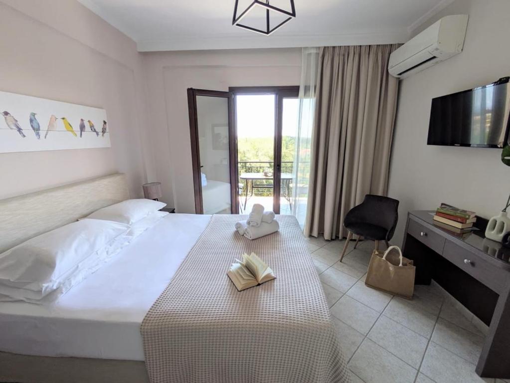 a hotel room with a bed with two books on it at Casa Marina in Syvota
