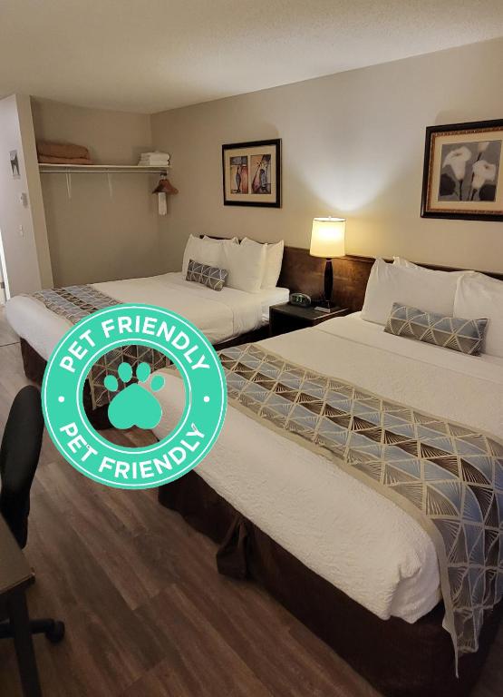 Un pat sau paturi într-o cameră la Recreation Inn and Suites Kelowna