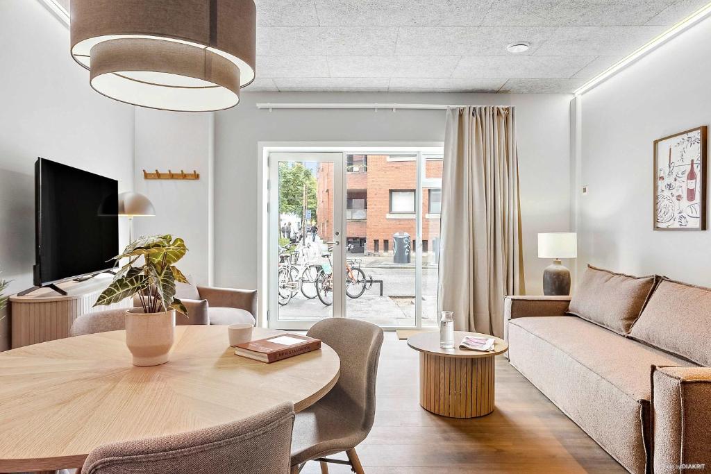 a living room with a table and a couch at Ground-Floor Living with Stylish Nordic Interiors in Aarhus