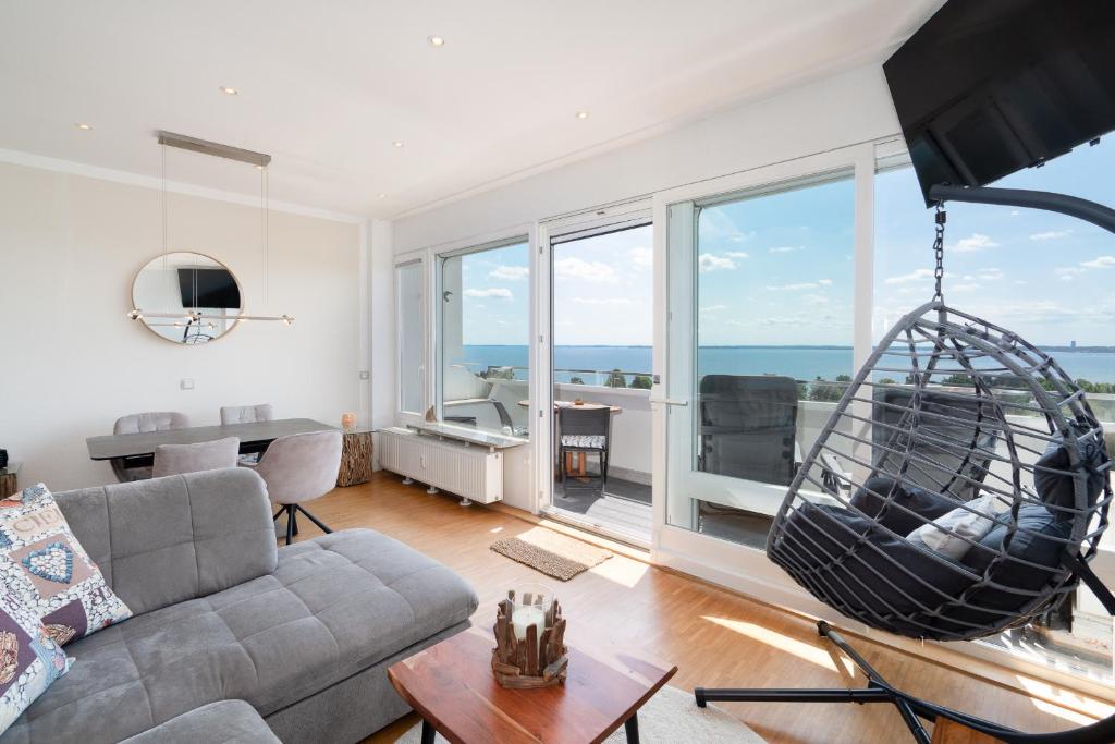 a living room with a couch and a swing at Panoramic App C09-8 in Sierksdorf
