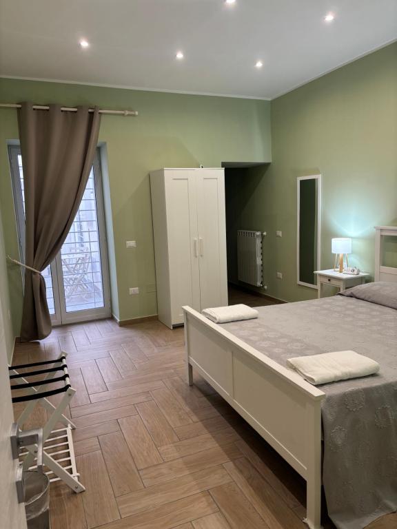 a bedroom with a large bed in a room at Don Mimì Casa Vacanza in Torre del Greco
