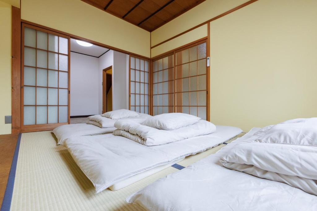 Postel nebo postele na pokoji v ubytování Guesthouse Fukufuku