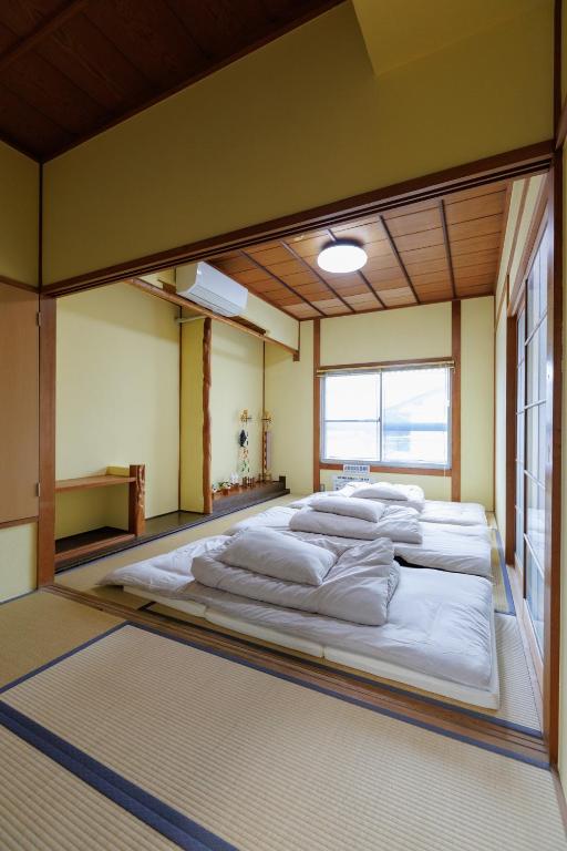 Postel nebo postele na pokoji v ubytování Guesthouse Fukufuku