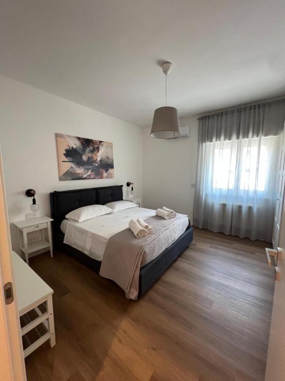 a bedroom with a large bed and a window at Ramò Apartments in Canicattì