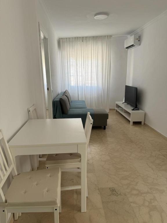 a living room with a table and a couch at Jardines del Porvenir in Puerto Real