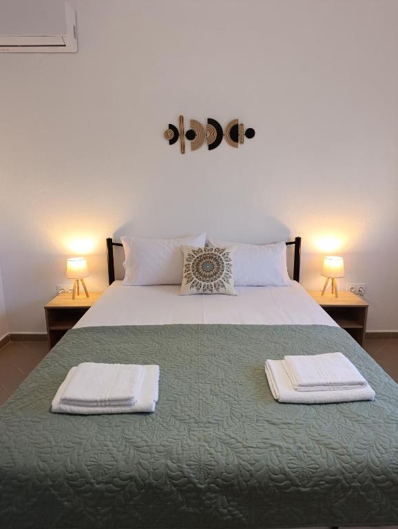 a bedroom with a bed with two towels on it at 3B House in Nea Vrasna