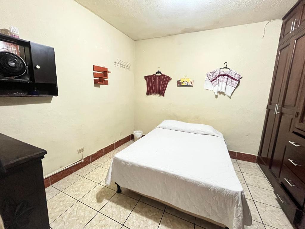 a hospital room with a bed and a tv at Jireh guesthouse in Antigua Guatemala