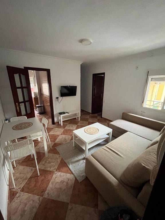 a living room with a couch and a table at Balneario Cachucha in Puerto Real