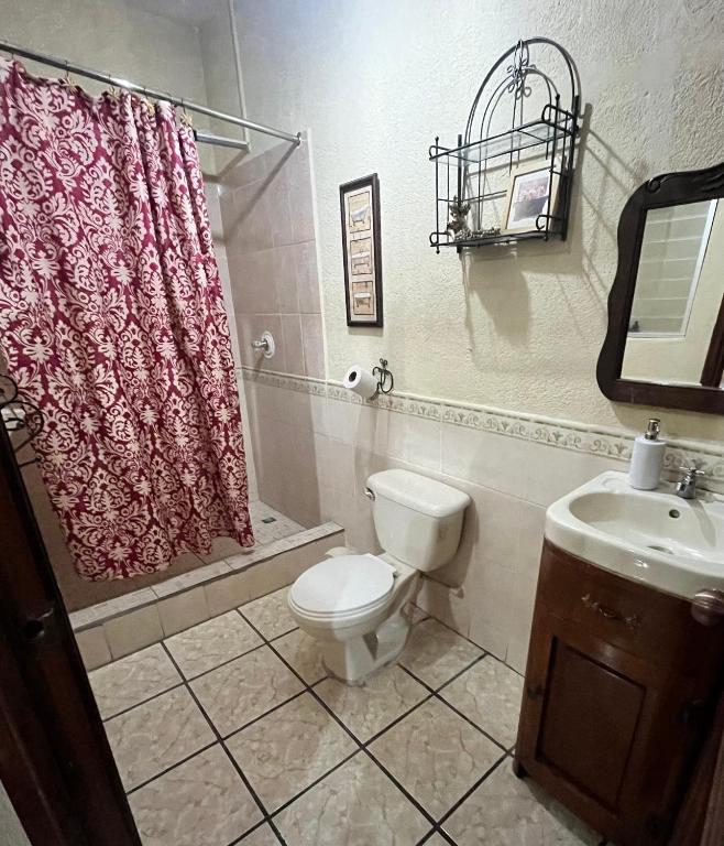 a bathroom with a toilet and a sink at Jireh guesthouse in Antigua Guatemala