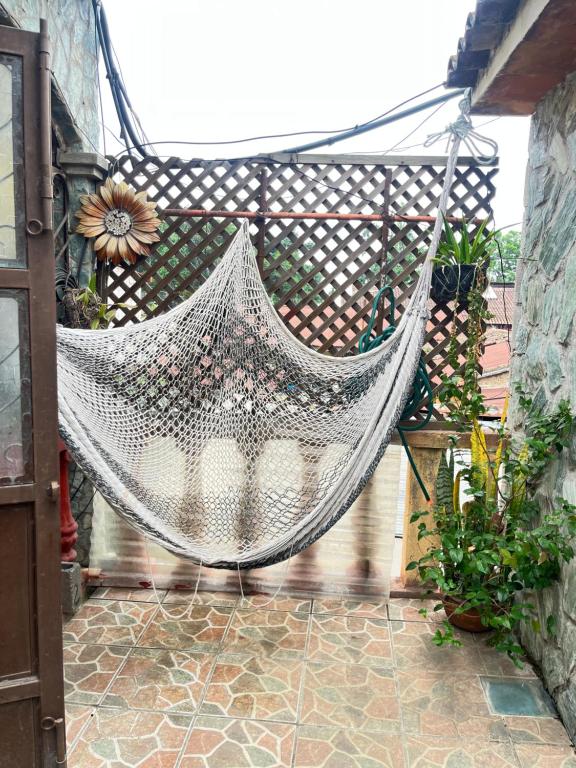 a hammock hanging from a fence on a patio at Jireh guesthouse in Antigua Guatemala
