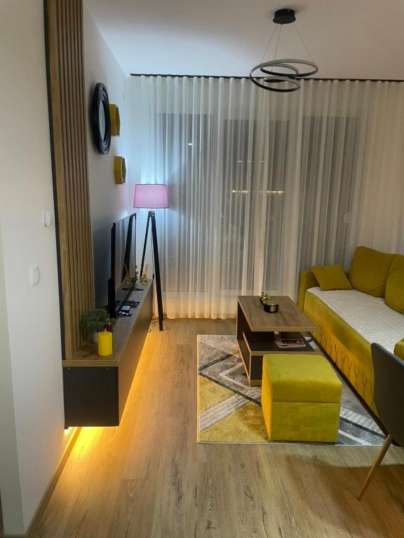 a living room with a couch and a table at Rajsko sunce in Vrnjačka Banja