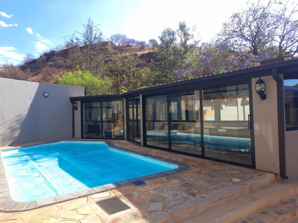 a house with a swimming pool in the backyard at Luxury Villa in Windhoek with Private Pool in Khomas Region