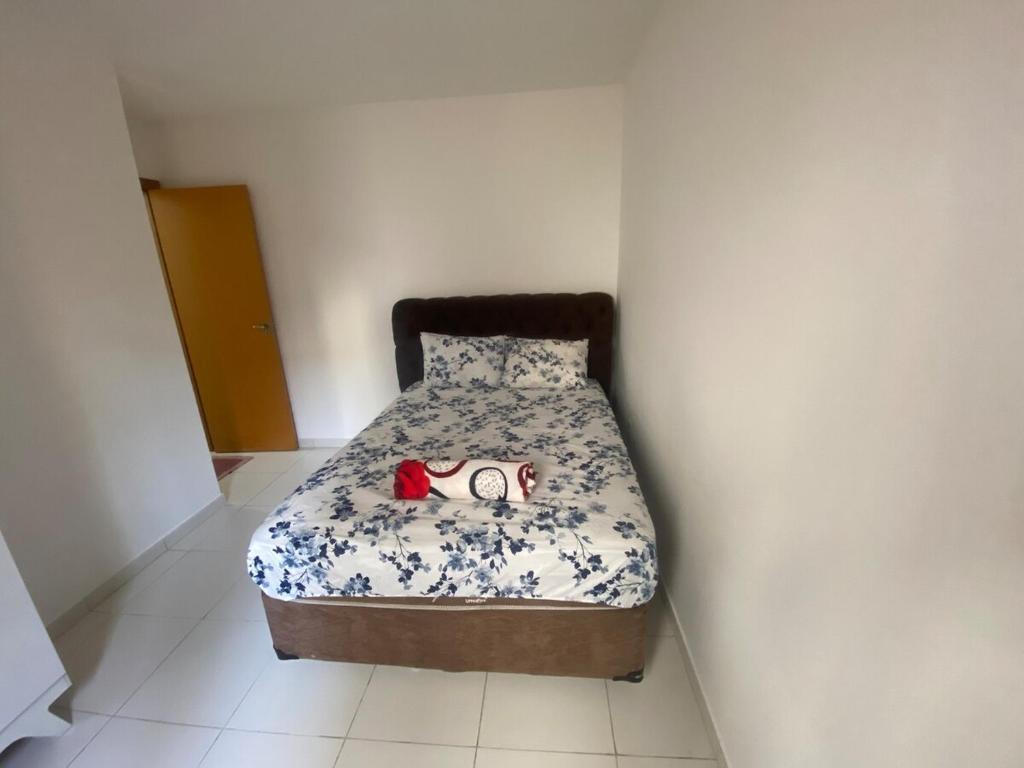 a bedroom with a bed with a stuffed animal on it at Apartment - Pedro Leopoldo in Pedro Leopoldo