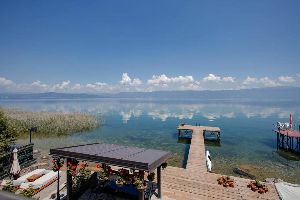 a dock in the water next to a lake at Vila Kladenci in Radožda