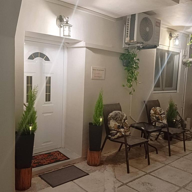 a living room with plants and a white door at Spiros dream house in Mesongi