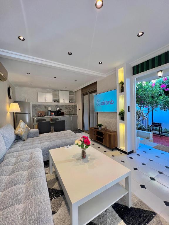 a living room with a couch and a table at Villa 3 Corniche, Charming Seaside Villa with Jacuzzi, Carrousel Mall Rabat in Rabat