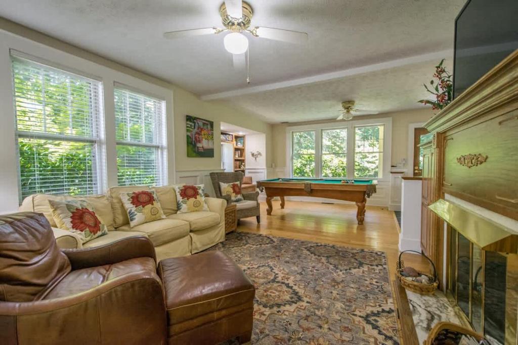 a living room with couches and a pool table at Historic 4BR Colonial with Pool Table and Fire Pit in Hendersonville